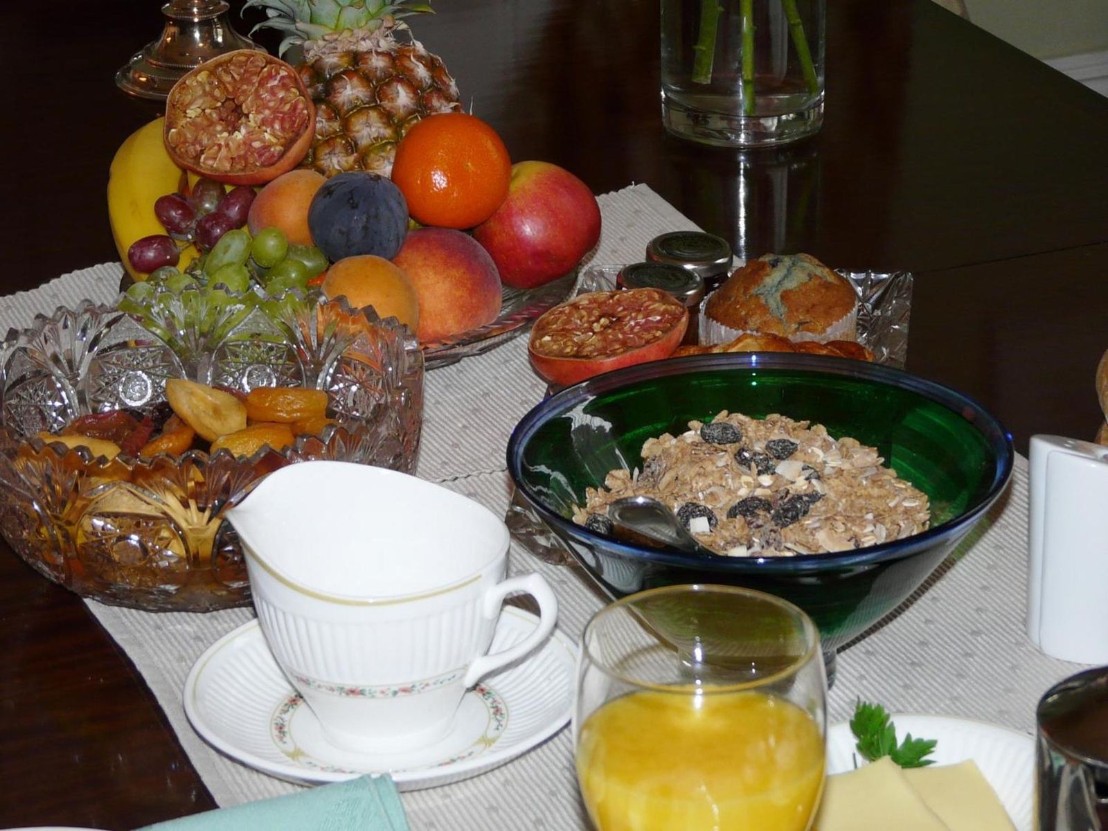 Breakfast table with fresh fruit, cereal, tea and juice